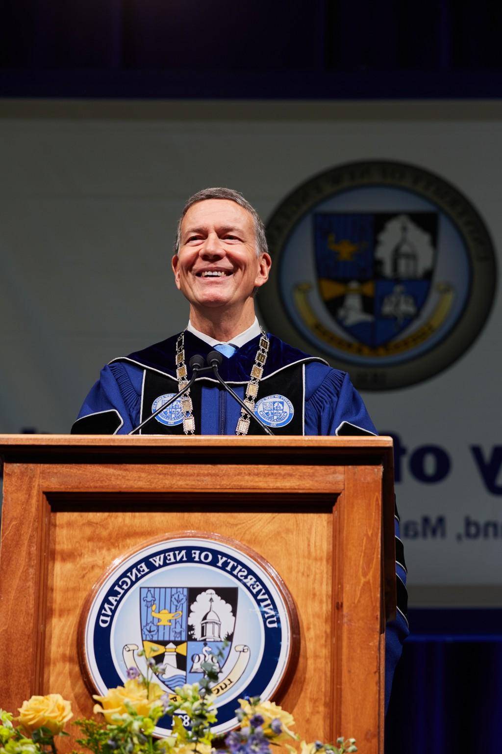 UNE President James Herbert smiles at the podium