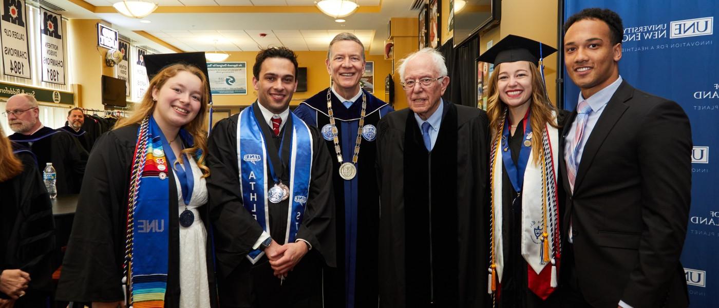 UNE President James Herbert poses with Bernie Sanders and students