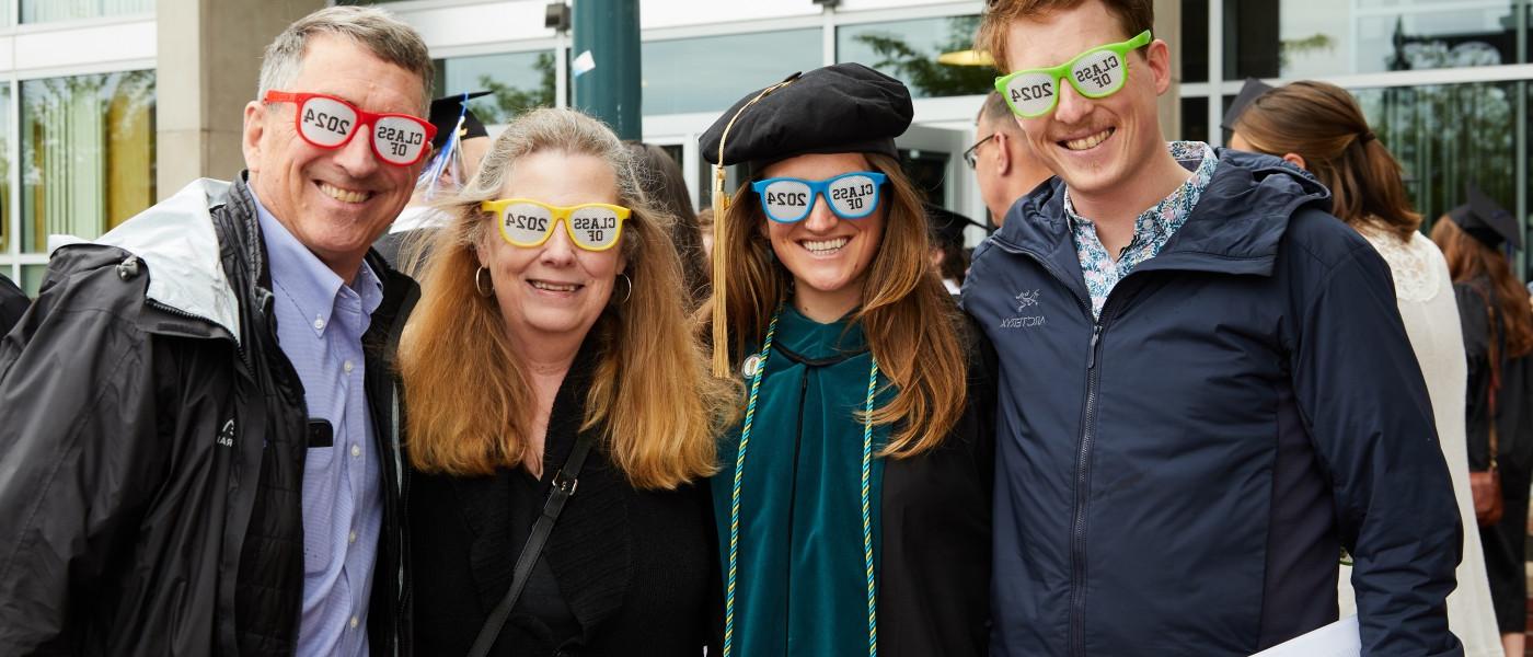 A family poses with "Class of 2024" sunglasses