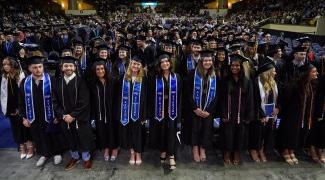 UNE graduates pose at the Cross Insurance Arena in Portland